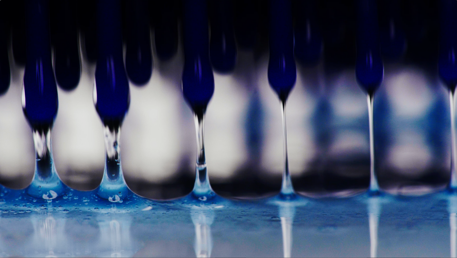 Close-up of a blue and white liquid droplet formation.
