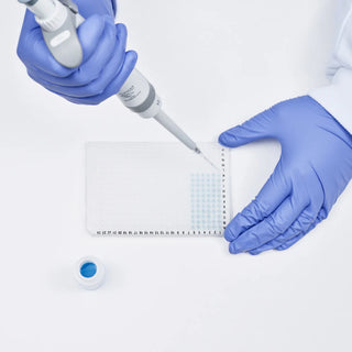 Person in blue gloves using a pipette on a white background