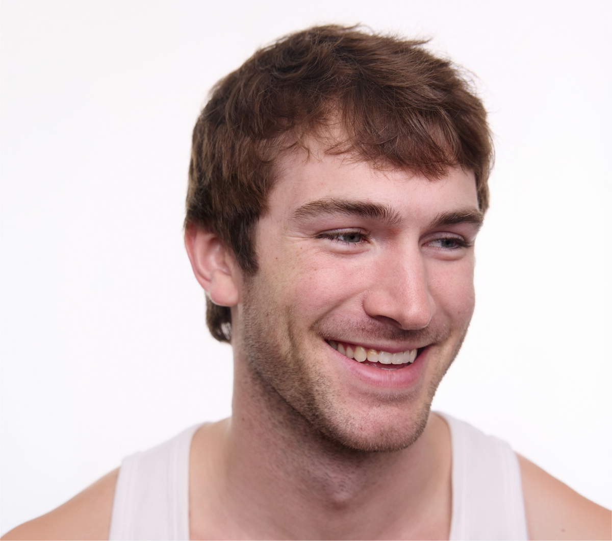 man smiling with hair growth