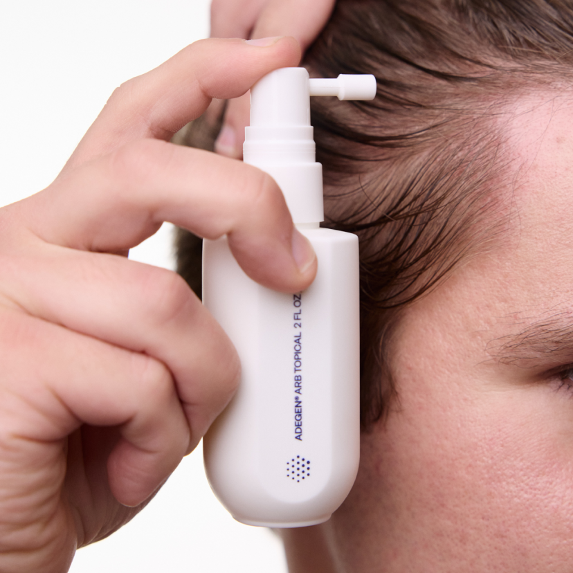 man using adegen topical formula on scalp