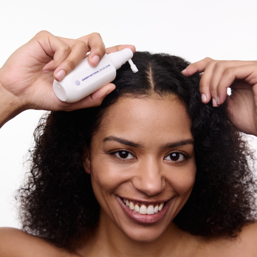 woman using adegen topical hair formula