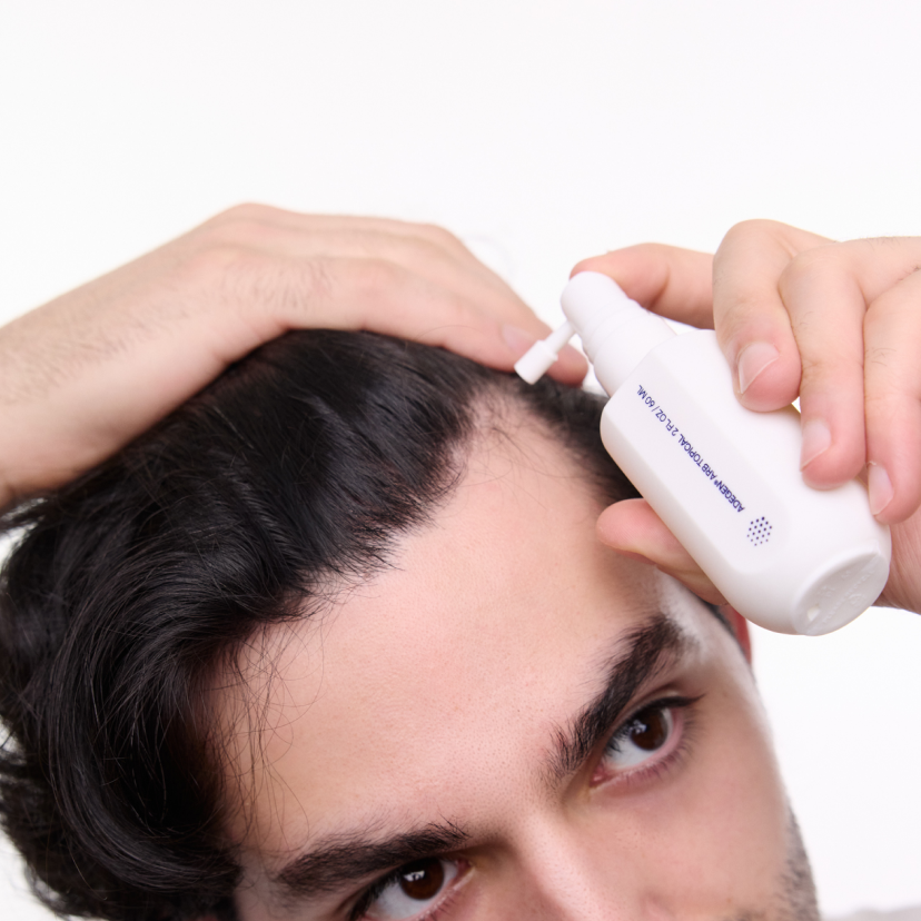 man using adegen topical hair formula on scalp